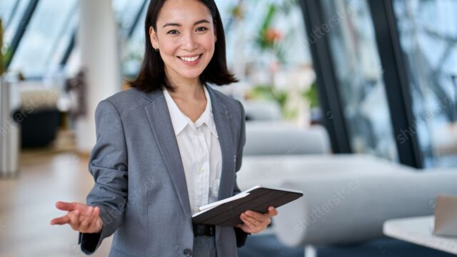 stock-photo-happy-young-asian-saleswoman-looking-at-camera-welcom